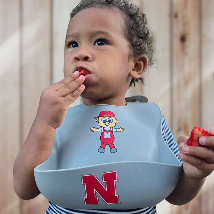 Nebraska Lil' Red Silicone Bucket Bib with Baby